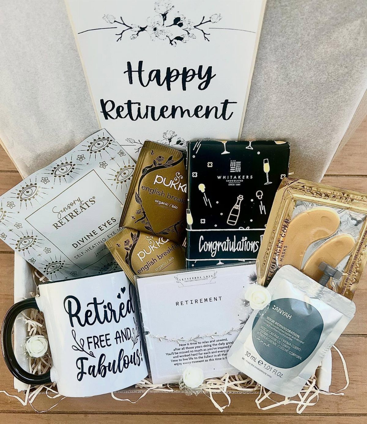Retirement gift basket with a themed mug, skincare products, and a celebratory card.
