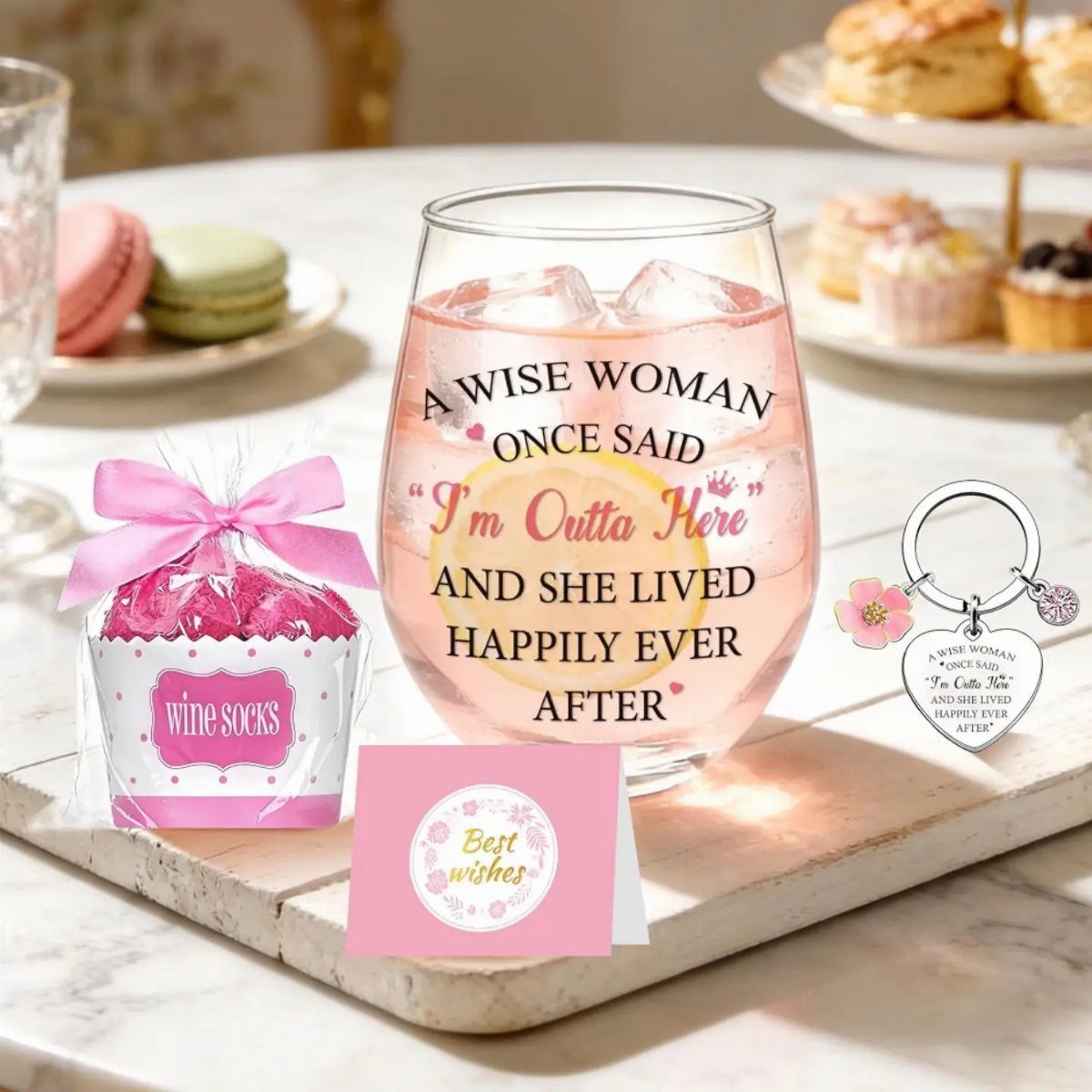 Retirement gift set with a wine glass, socks, keychain, and card on a board.