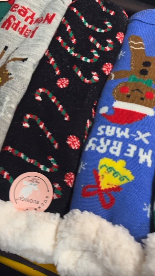 Festive Christmas socks in grey, black, and blue with fuzzy white linings.