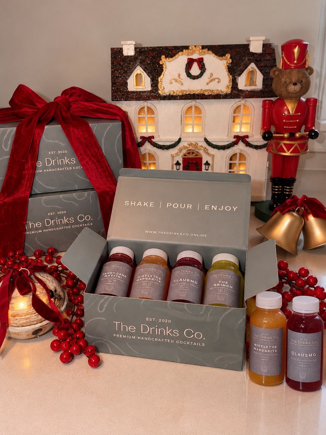Cocktail mixer gift set in a grey box with festive holiday decorations.