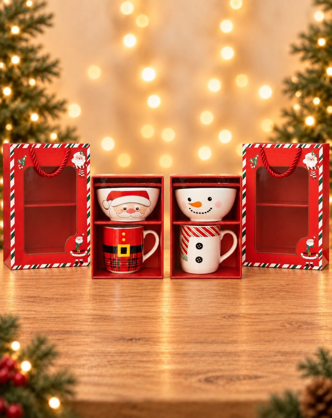 Christmas themed Santa and snowman mugs in red gift boxes on wooden table