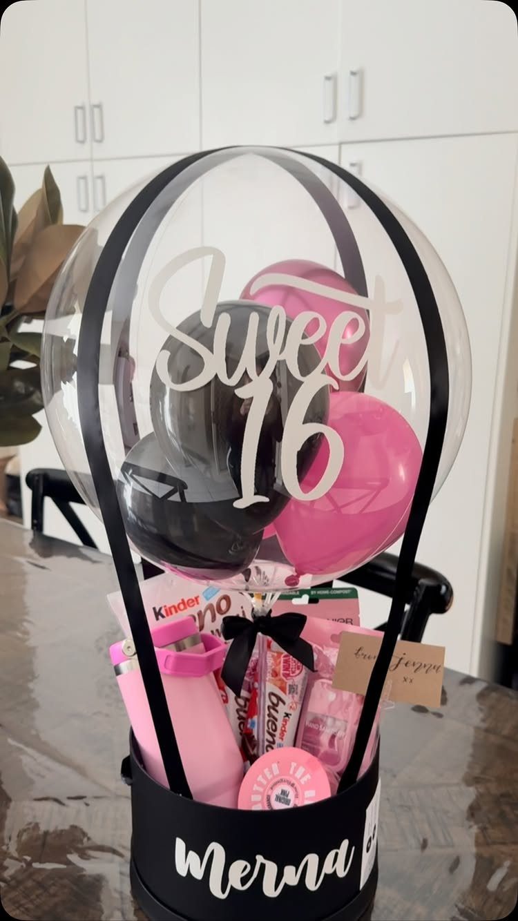 Sweet 16 gift arrangement with a large clear balloon and pink treats.