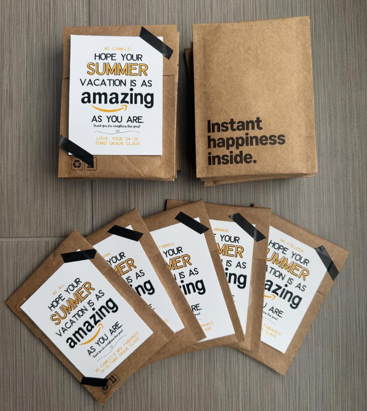 Brown paper envelopes with summer vacation cards and Amazon gift cards inside.