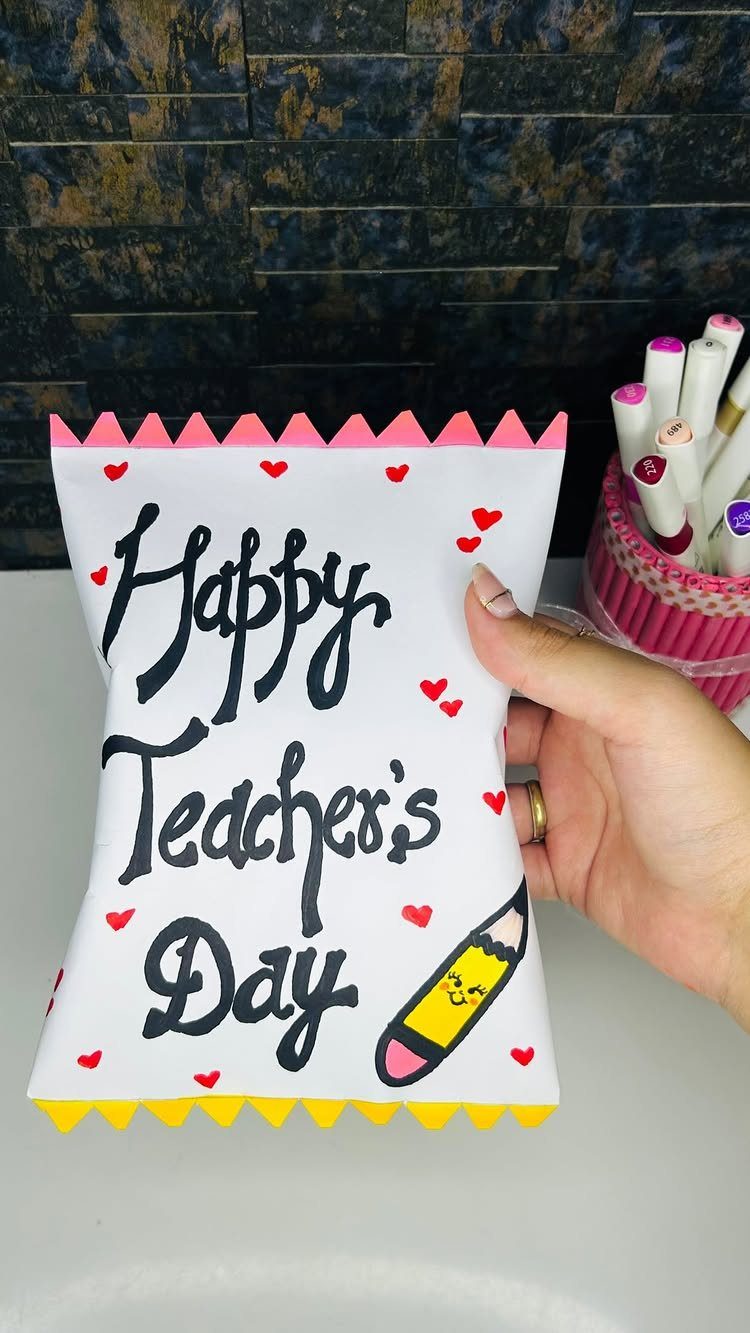 Handmade white gift bag with Happy Teacher's Day lettering and a pencil drawing.