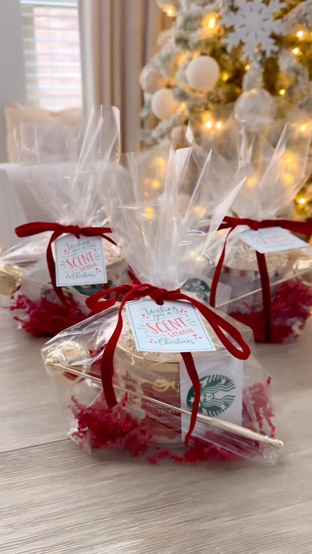 Gift bundles with white candles, Starbucks gift cards, and red ribbons for Christmas.