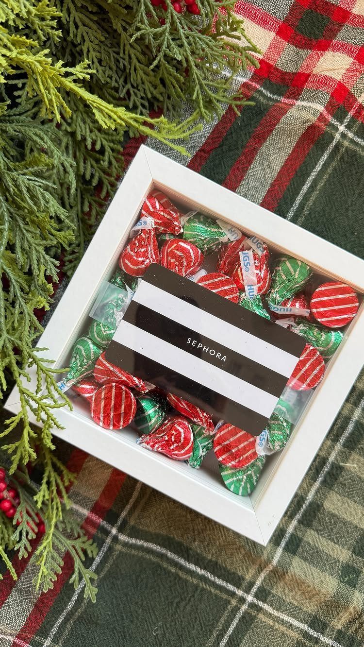 Sephora gift card surrounded by red and green candies in a white frame.