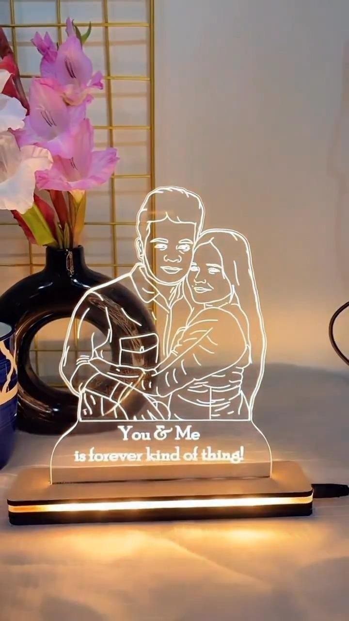 Etched acrylic lamp of a couple embracing with romantic text on wooden base