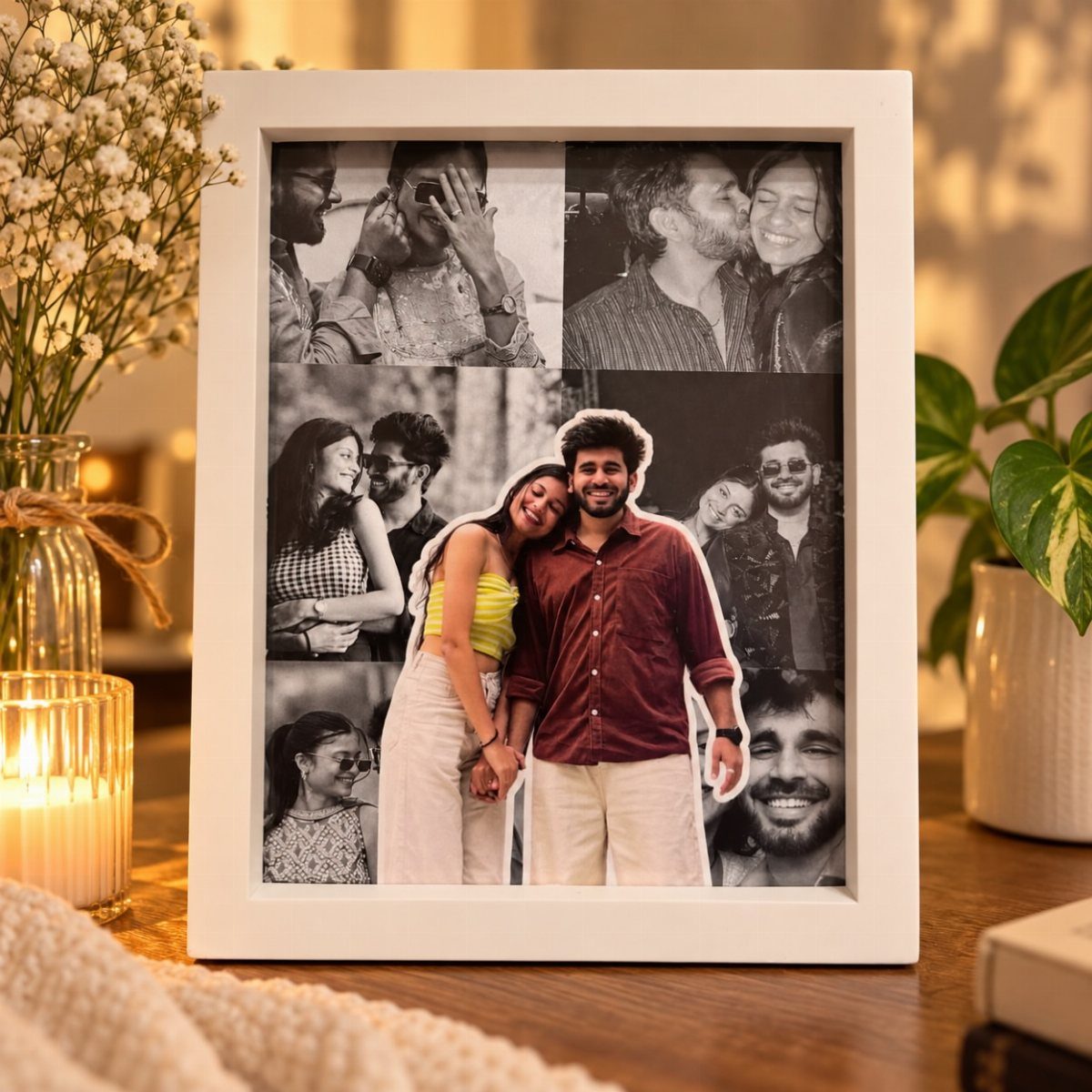 White photo frame with a collage of couple photos on a wooden table