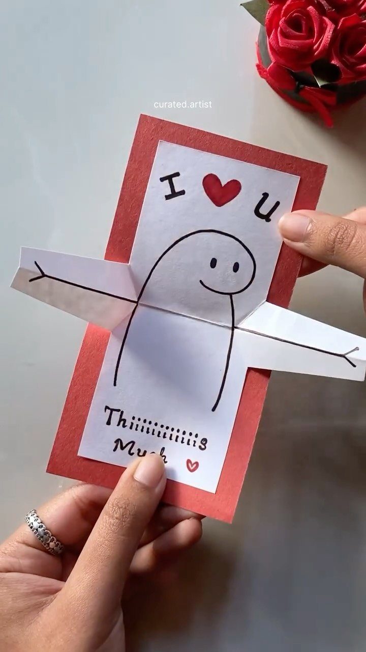 Handmade Valentine's card with a character and long foldable arms saying I love you