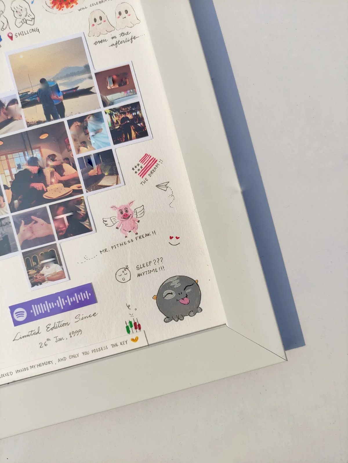 Handmade scrapbook page with couple photos, cute drawings, and handwritten romantic notes.