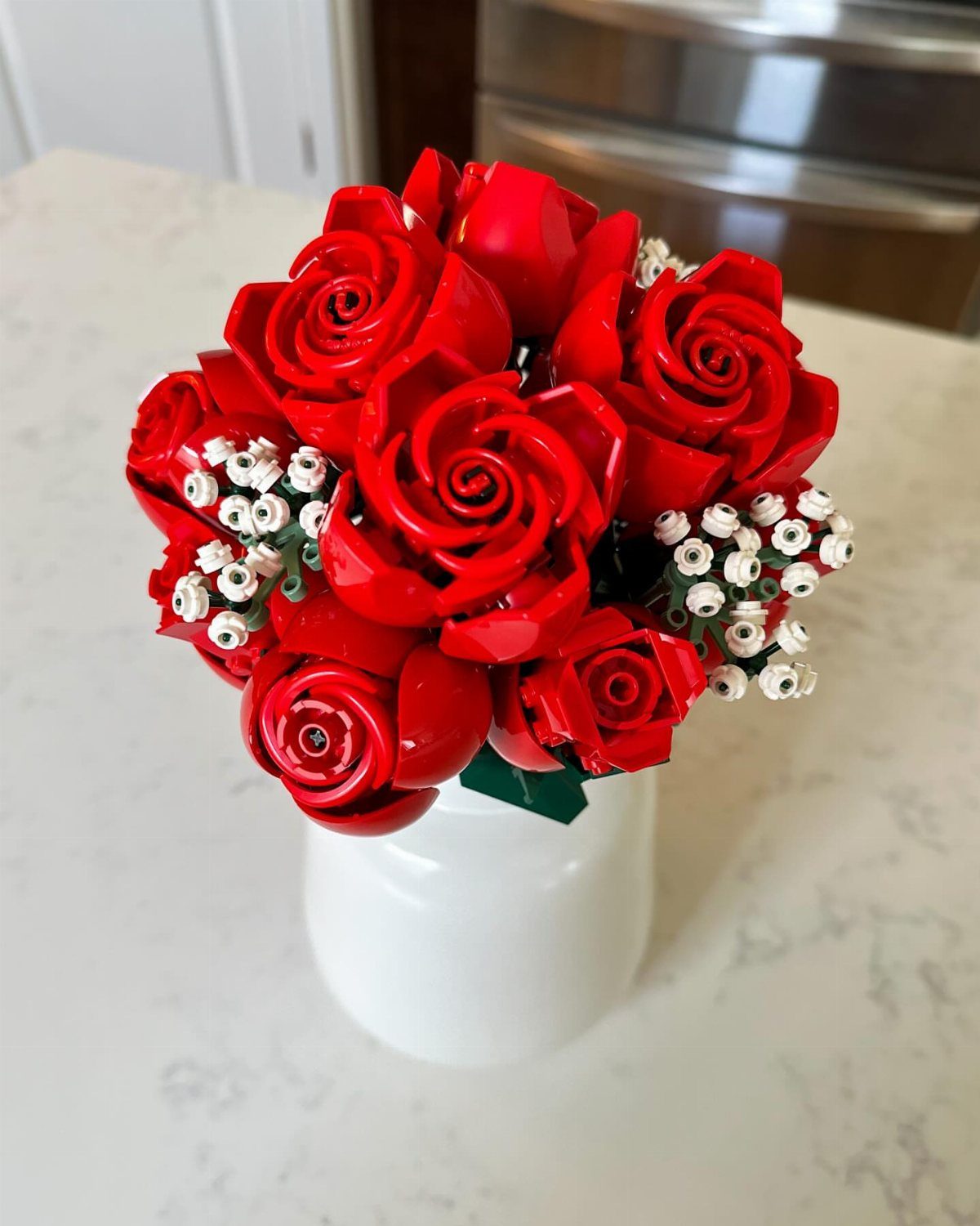 LEGO red rose bouquet with white baby's breath in a white ceramic vase