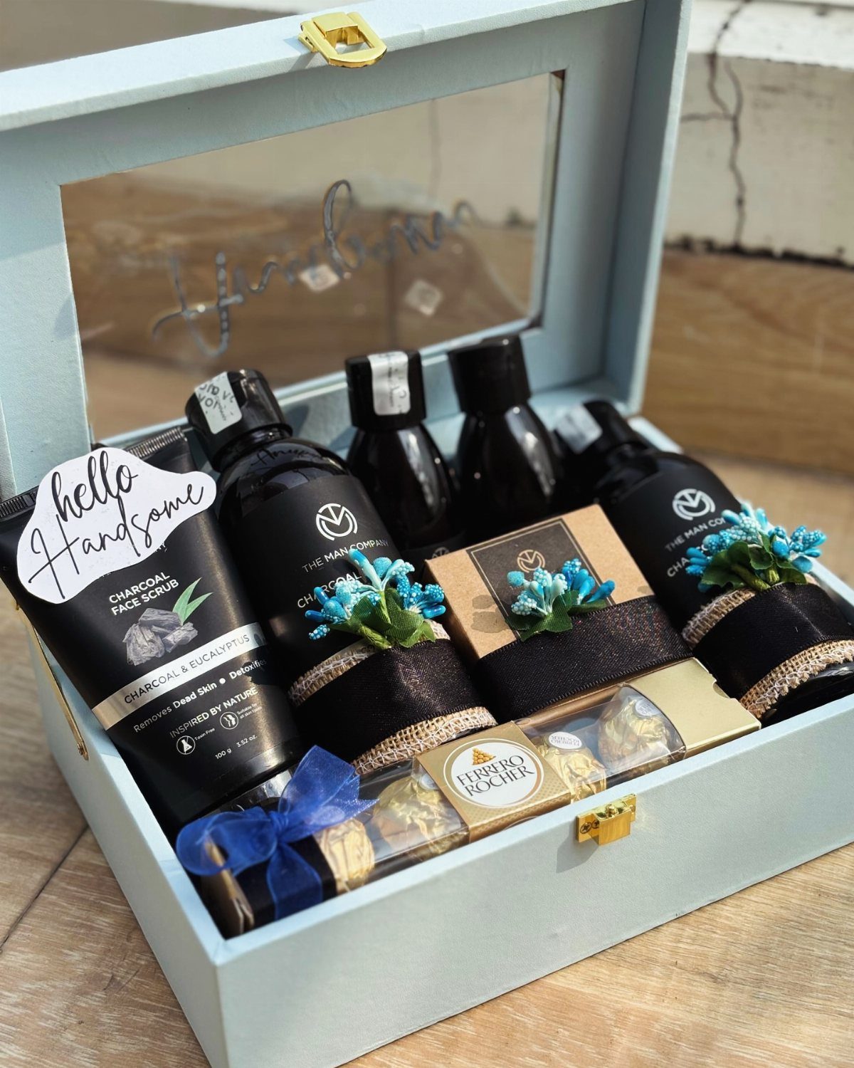 Grooming gift set in a blue box with skincare products and chocolates.