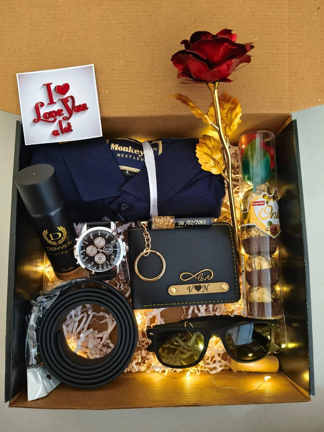 Gift box for men with shirt, watch, wallet, belt, and a red rose.