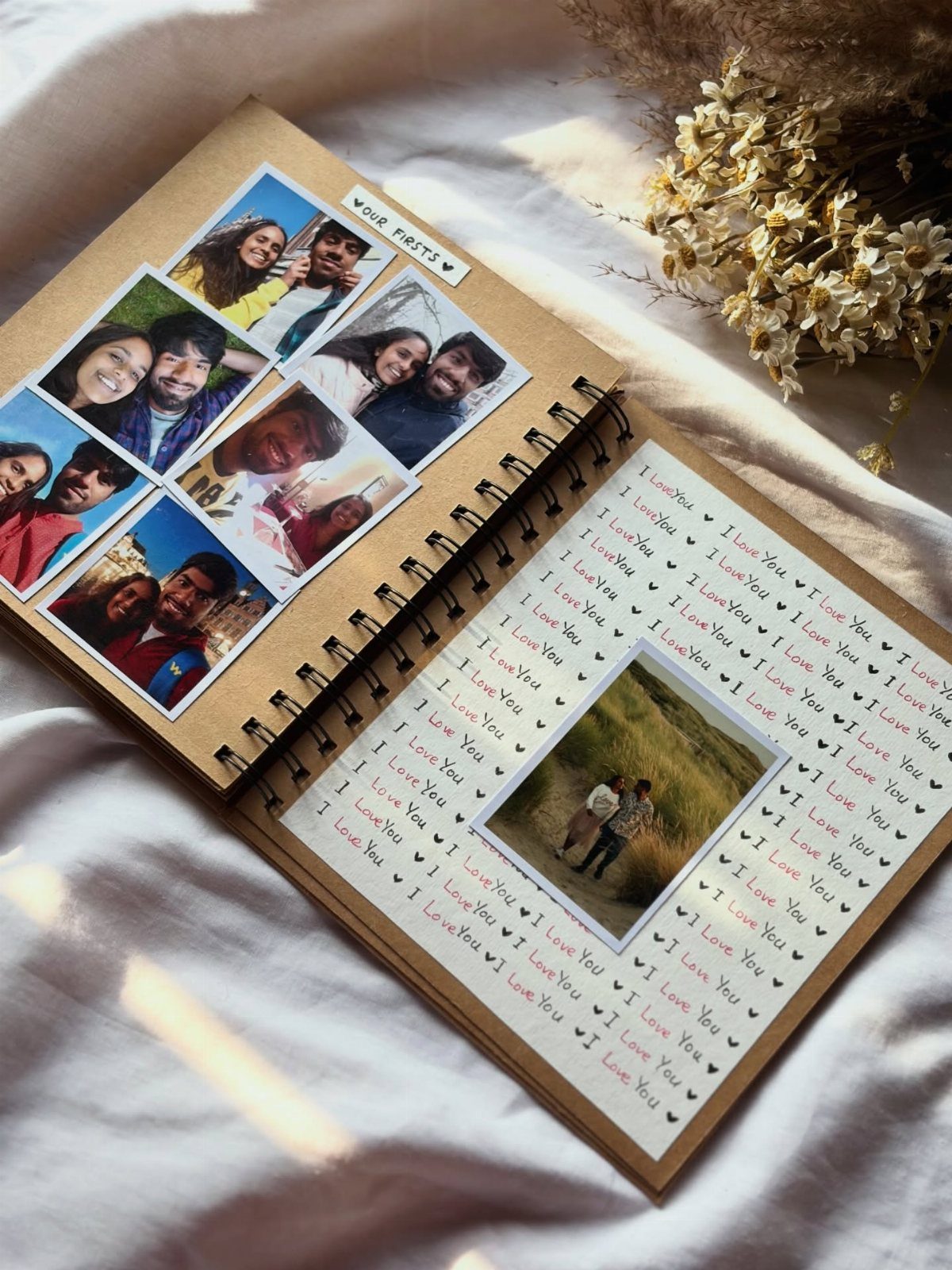 Open scrapbook with couple photos and love notes on white fabric background
