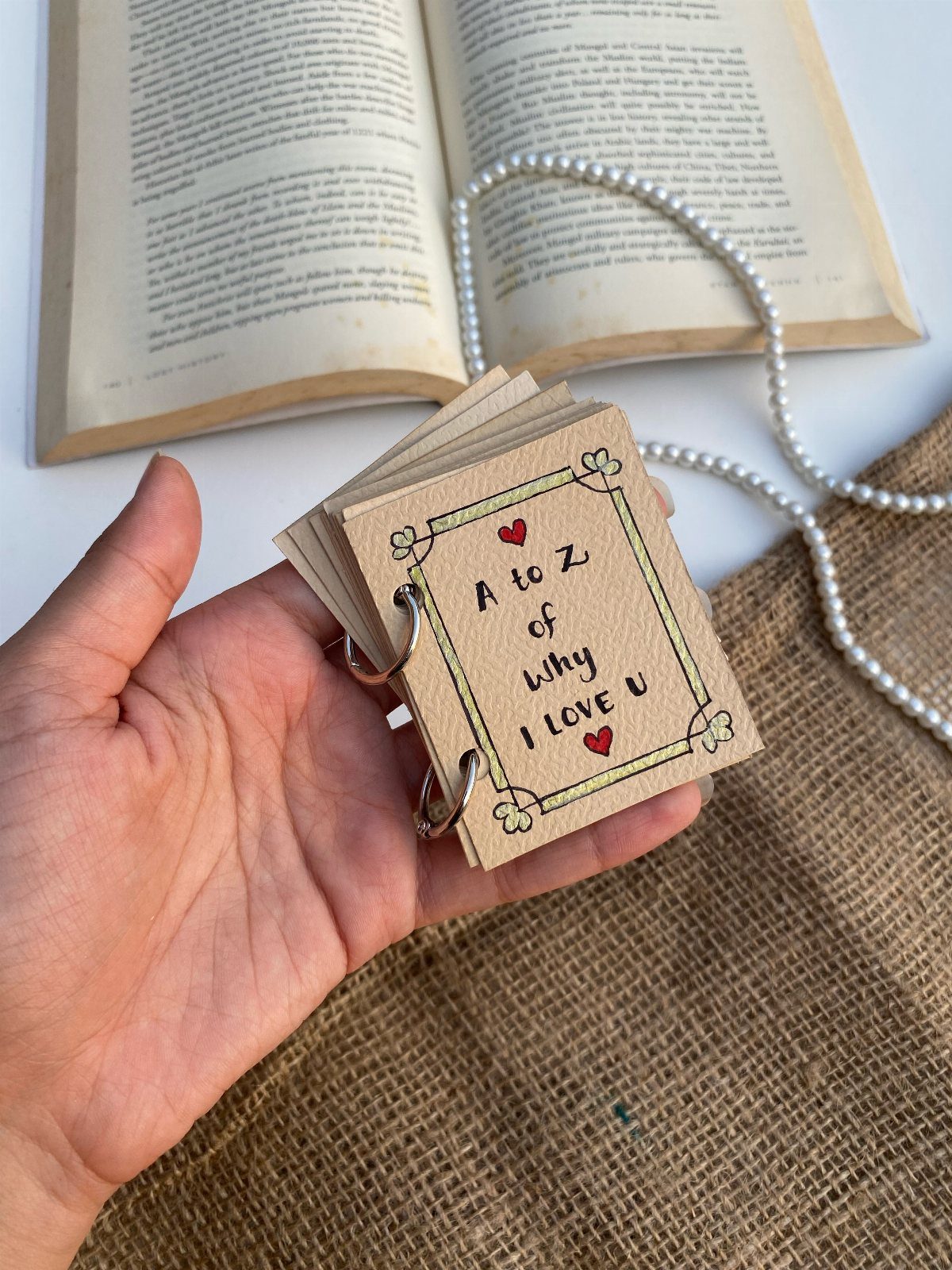 Handmade ring-bound booklet titled A to Z of Why I Love U with hearts.