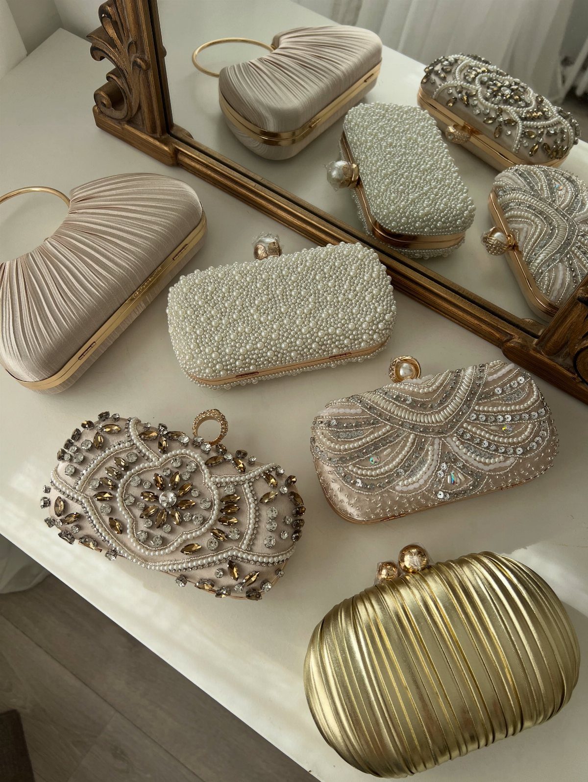 Formal evening clutches in gold and champagne satin with pearl and crystal embellishments.