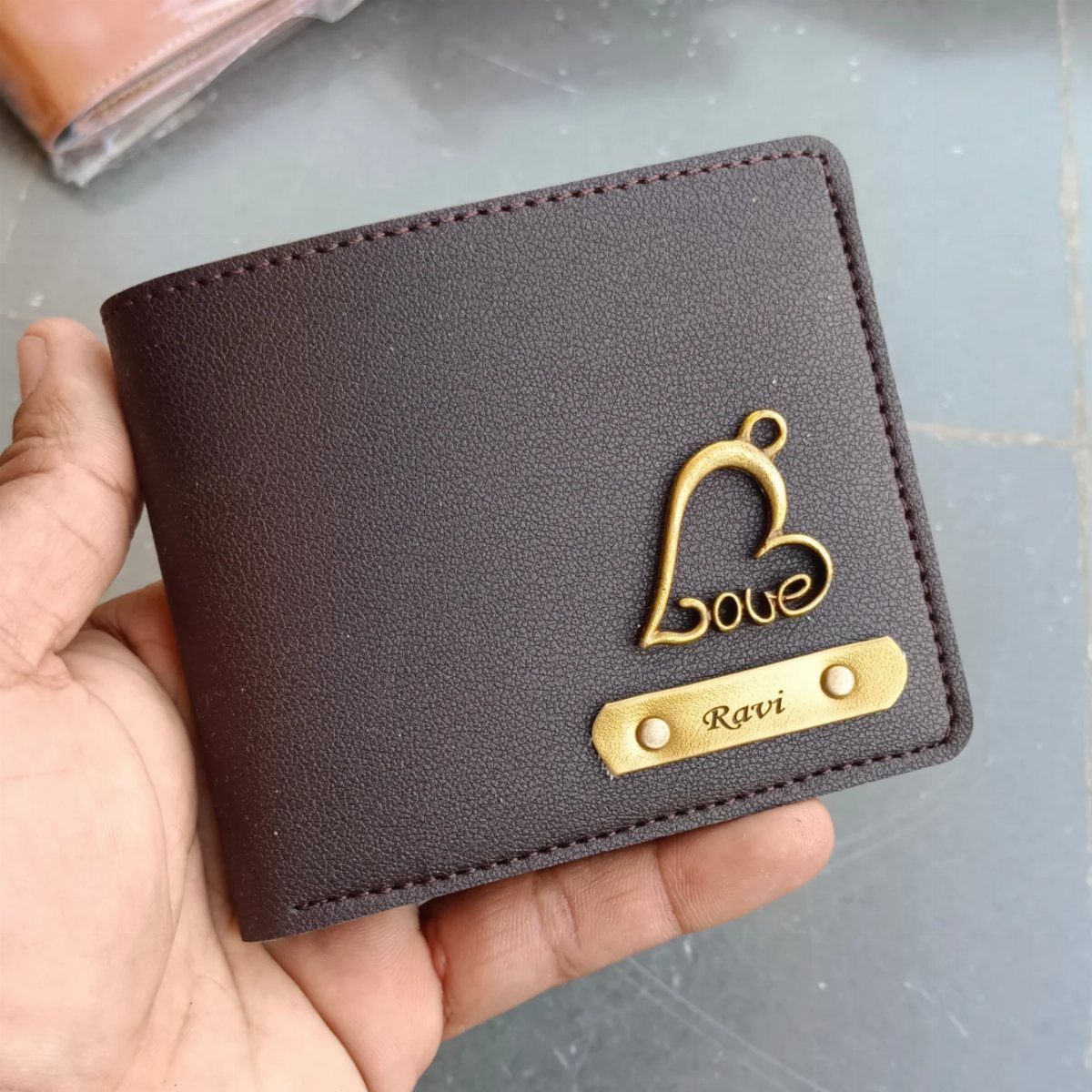 Brown leather wallet with a gold heart charm and personalized name plate Ravi
