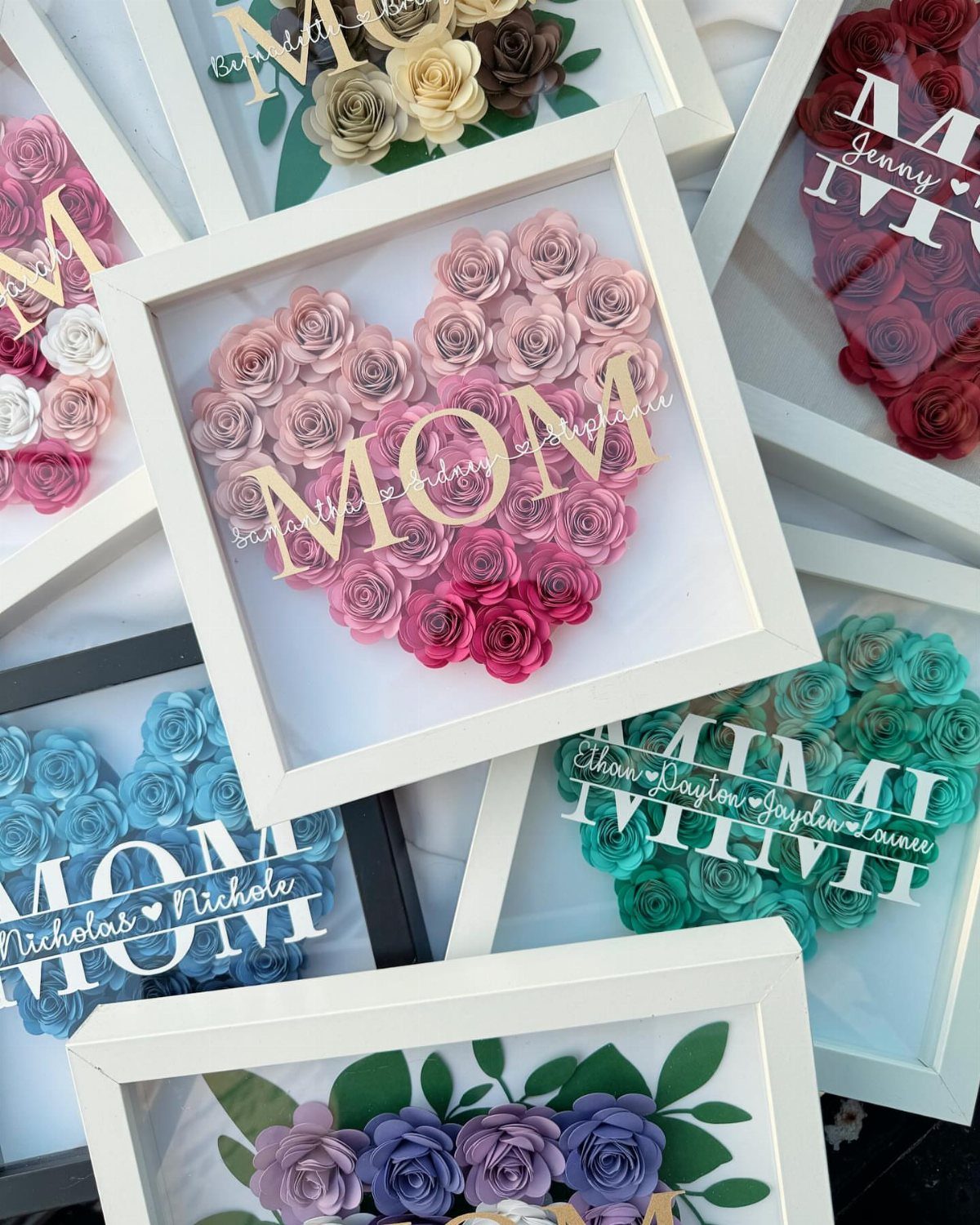 Heart-shaped paper rose arrangements in frames with personalized text for Mom and Mimi.