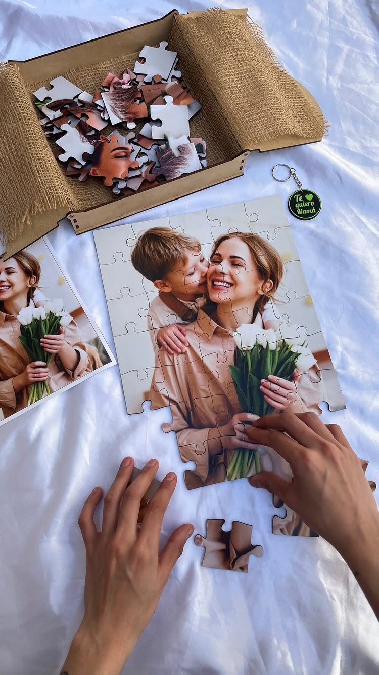 Custom jigsaw puzzle of a mother and child being assembled on white fabric.