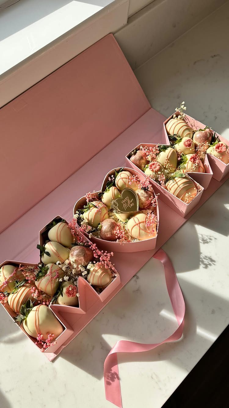 Chocolate covered strawberries in a pink heart-shaped gift box with pink flowers