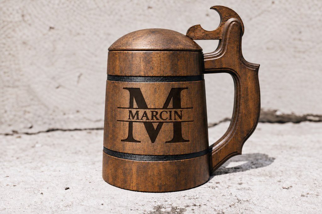 Wooden beer stein with a lid and the name Marcin engraved on it.