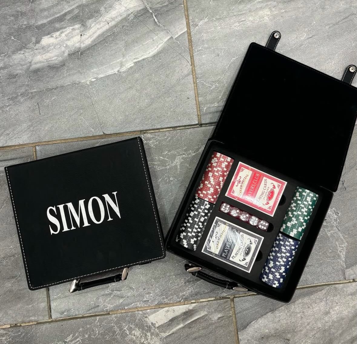 Personalized black leather poker set with chips and cards on marble floor