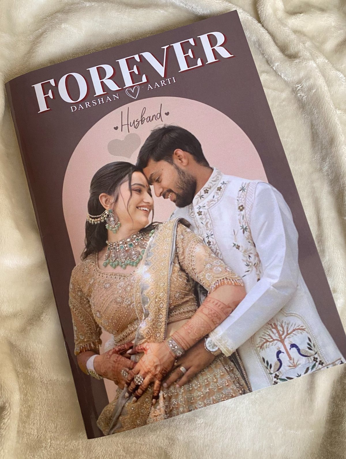 Personalized photo book with a couple in wedding attire on a fluffy white background