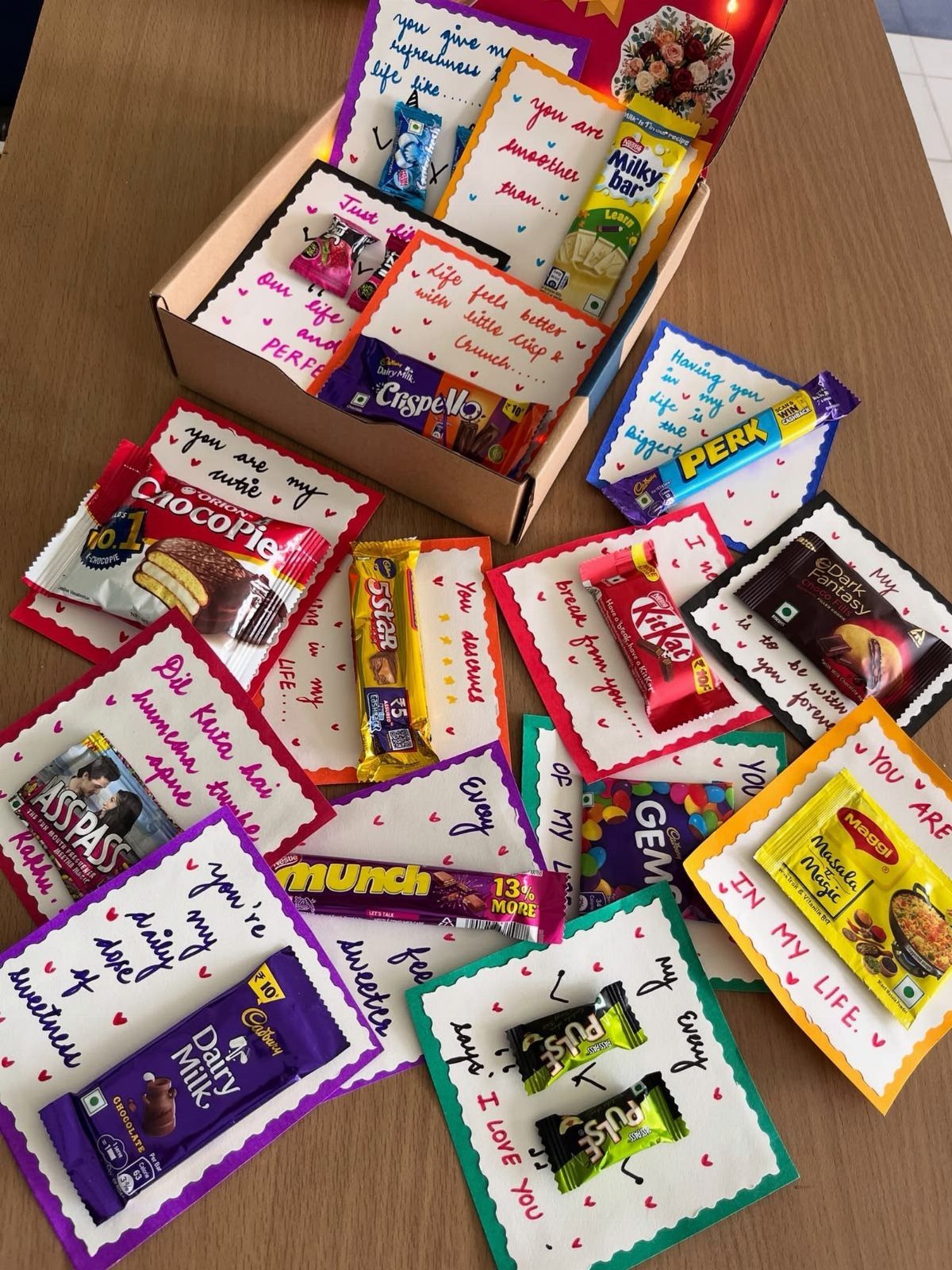 Handmade romantic gift cards with various chocolate bars and handwritten love notes.
