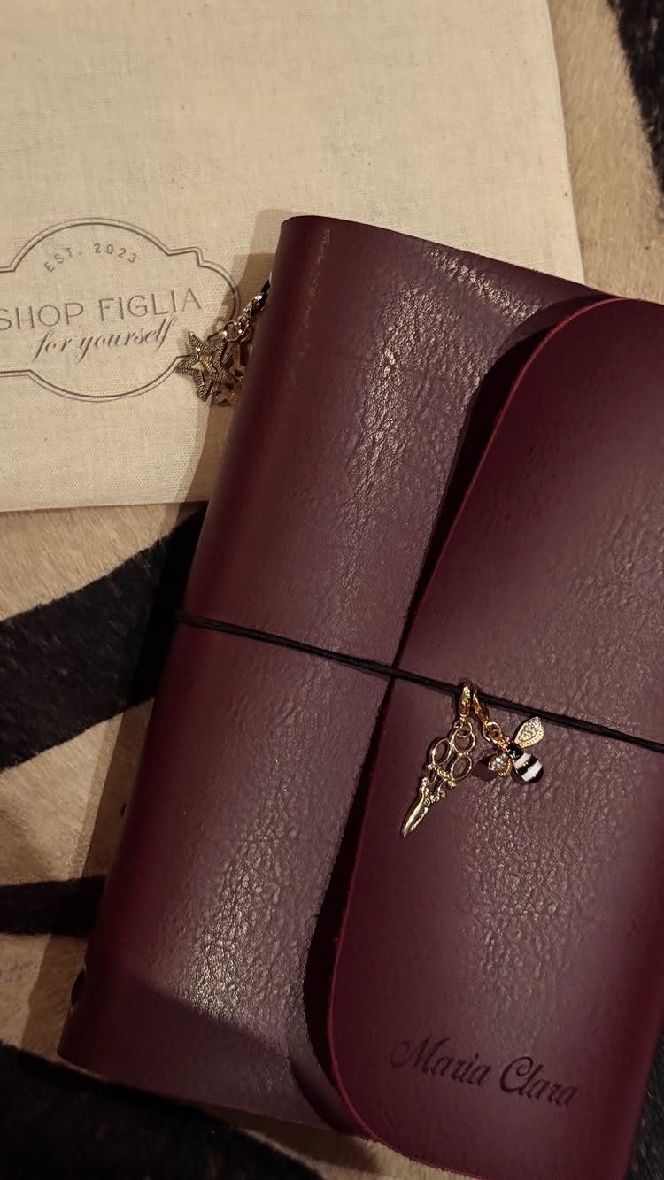 Burgundy leather notebook with gold bee charm and embossed name on cover