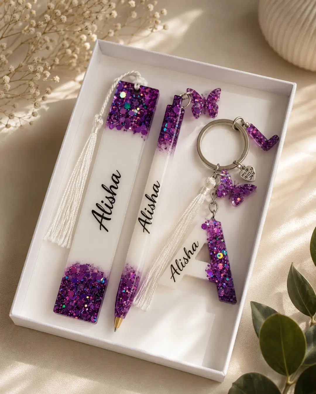 Personalized resin bookmark, pen, and keychain with purple glitter and name Alisha.