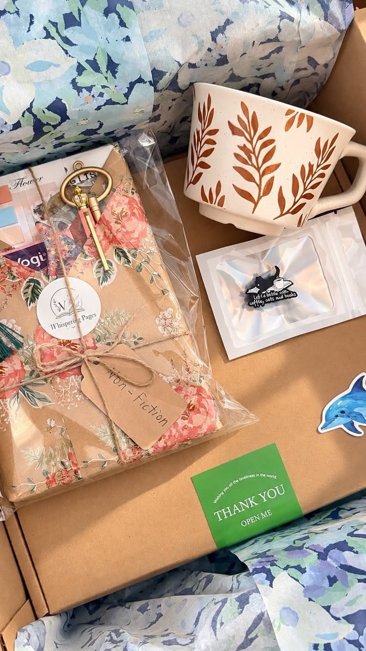 Floral wrapped non-fiction book and leaf-patterned mug in a gift box