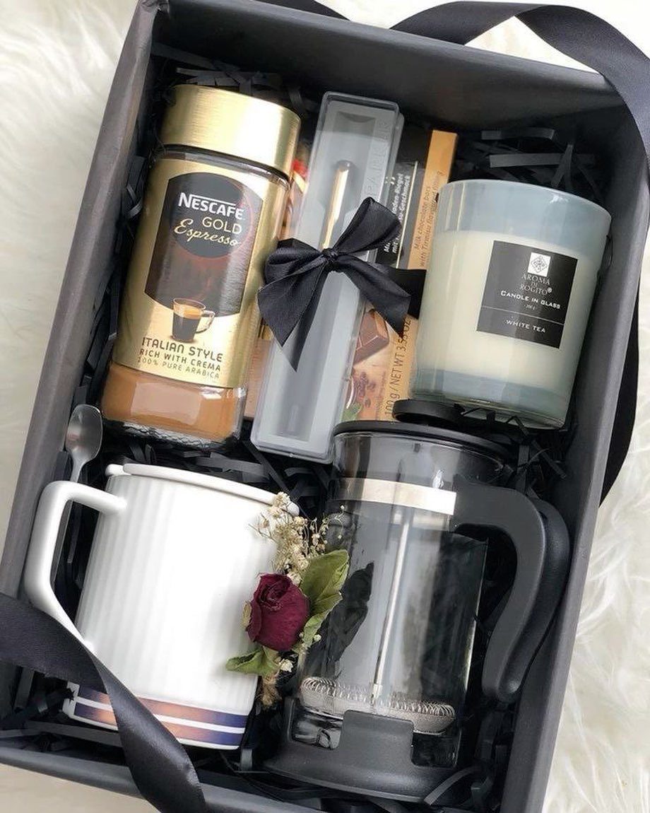 Coffee gift set in a grey box with espresso, French press, and mug.