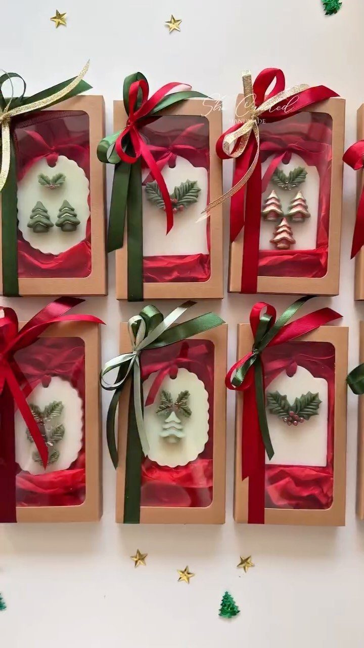 Small brown gift boxes with ribbons containing tree-shaped chocolates for Christmas gifts.