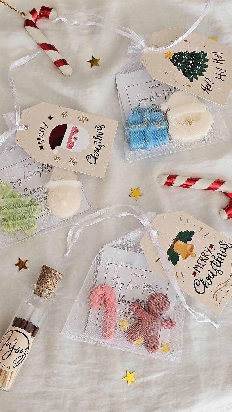 Small Christmas gift bags with miniature soaps, candy canes, and festive tags.