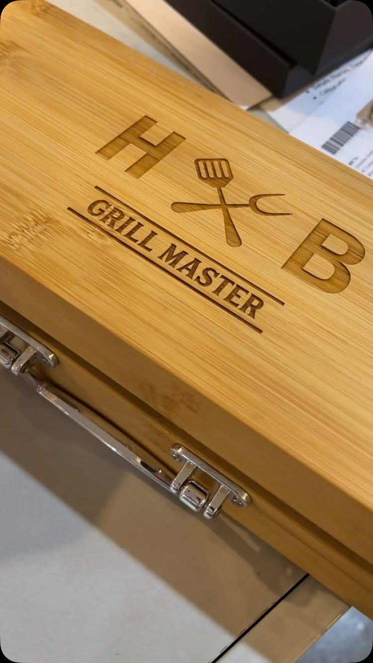 Wooden grill master tool box with engraved letters and grilling utensils icon