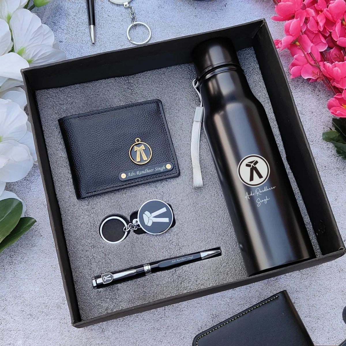 Personalized black leather wallet, water bottle, and pen in a black gift box.